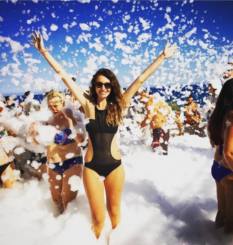 A woman dancing at an adult foam party