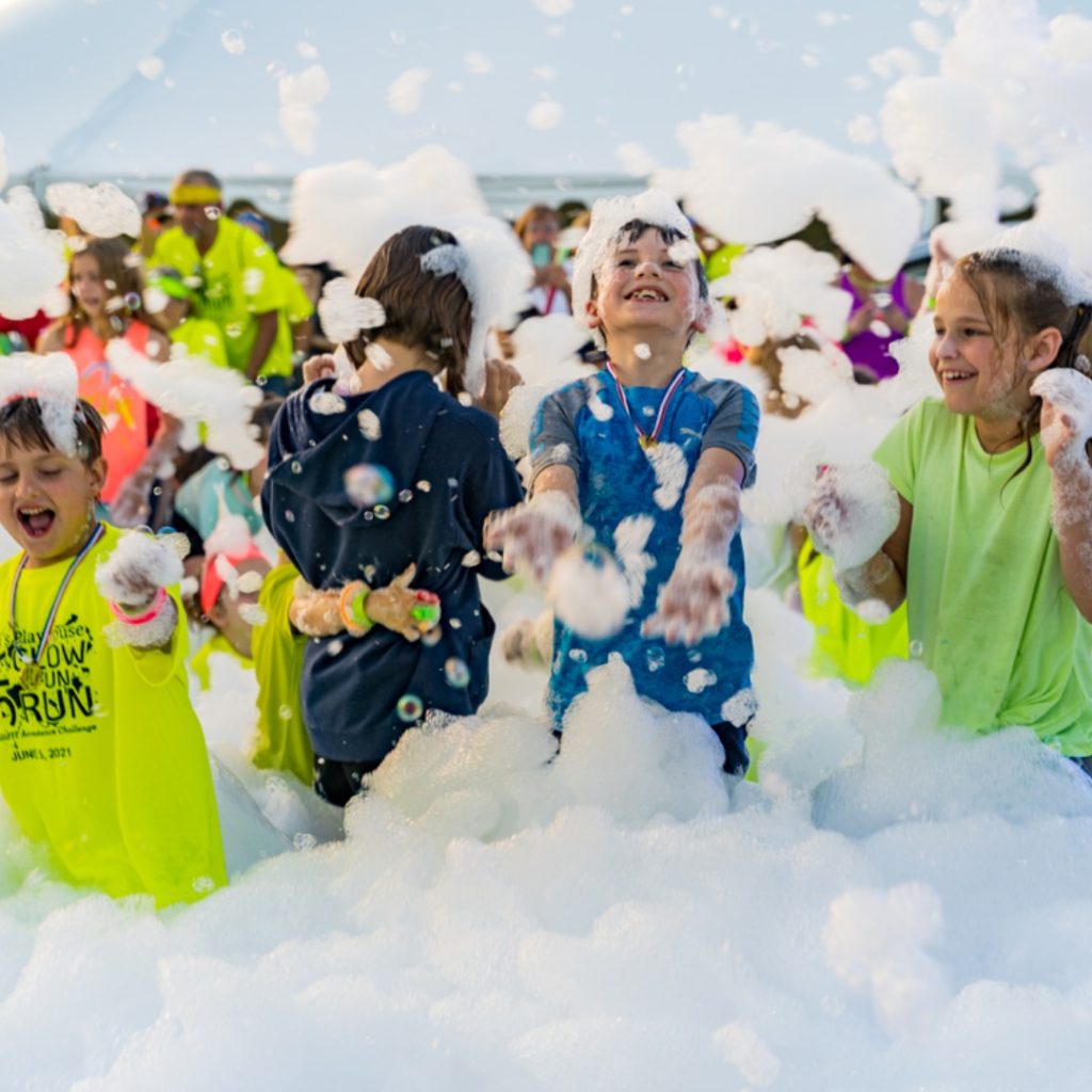 Kids playing at a foam party